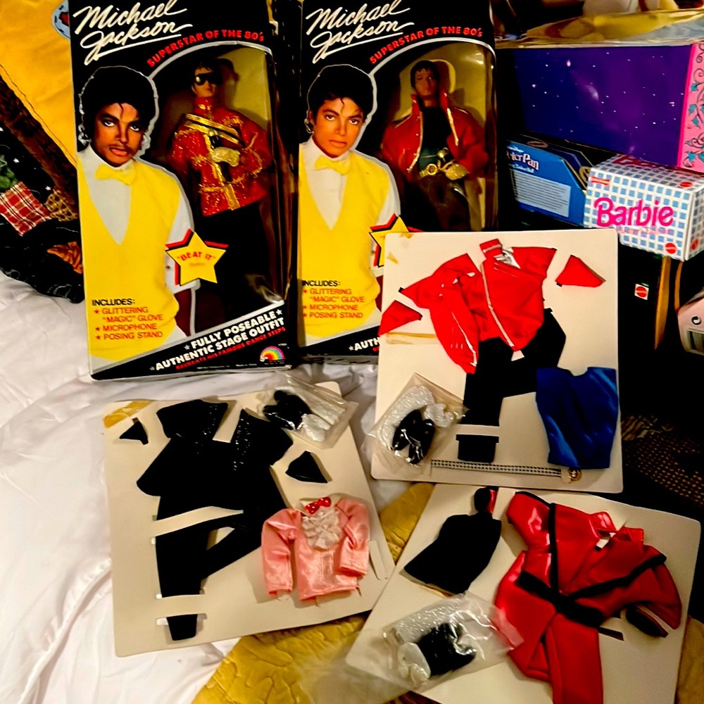 Two Michael Jackson dolls and three outfits